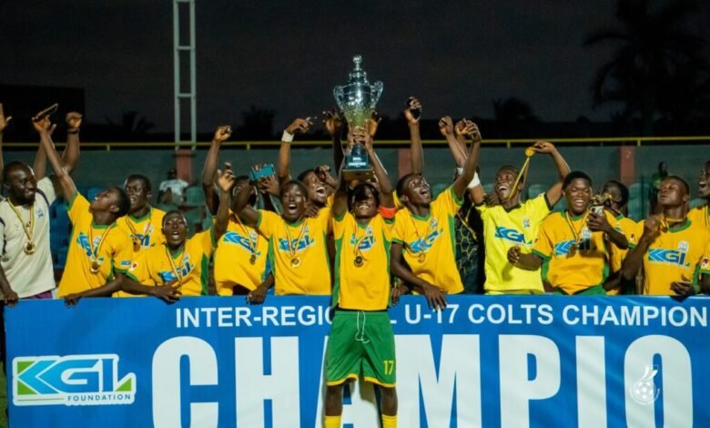 Captain of Ashanti, Agyei Duah, lift high the winner's trophy while his teammates celebrate