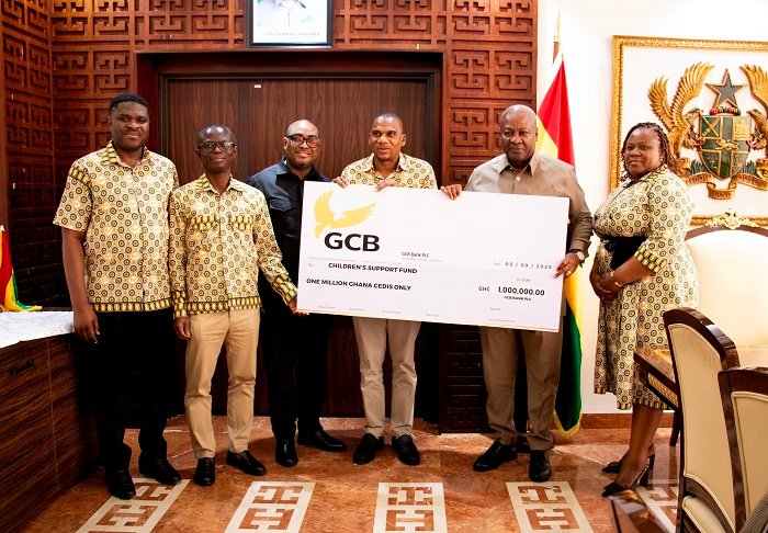 • President Mahama (second from right) recieving a dummy cheque from Mr Alhassan (third from right). Looking on are other officials of GCB