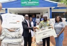 • Mr Mumuni (middle) presenting the items to Dr Armah