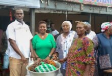 • Ms Sowah (second from right) and Mr Anyetei (left) assisting a beneficiary with items (inset)