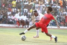 • Emmanuel Quartey of La Town XI controls the ball ahead of Julius Konya