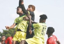 • Kotoko goalkeeper Camara Mohammed grabs the ball away from two Gold Stars players during the game