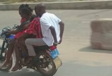 • Four people riding on a motor bike