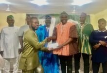 • Alhaji Mahama presenting the support to one of the beneficiary at the programme