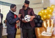 • Mr Ampofo Ankrah and Dr Blessing Ackah (left) admiring a souvenir after the Matchday Booklet was launched