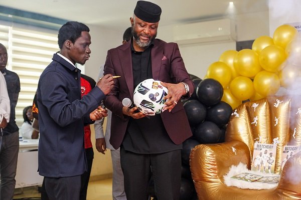 • Mr Ampofo Ankrah and Dr Blessing Ackah (left) admiring a souvenir after the Matchday Booklet was launched