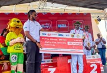 • Mr Dadey (left) presenting the winners prize to Gilbert Kiprotich