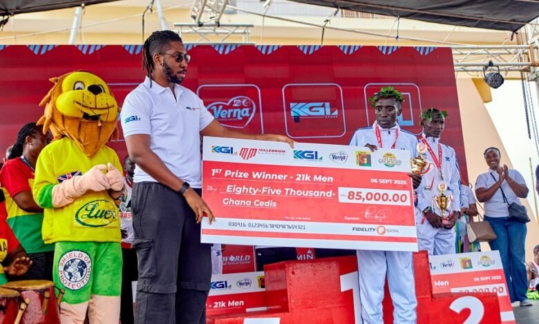 • Mr Dadey (left) presenting the winners prize to Gilbert Kiprotich