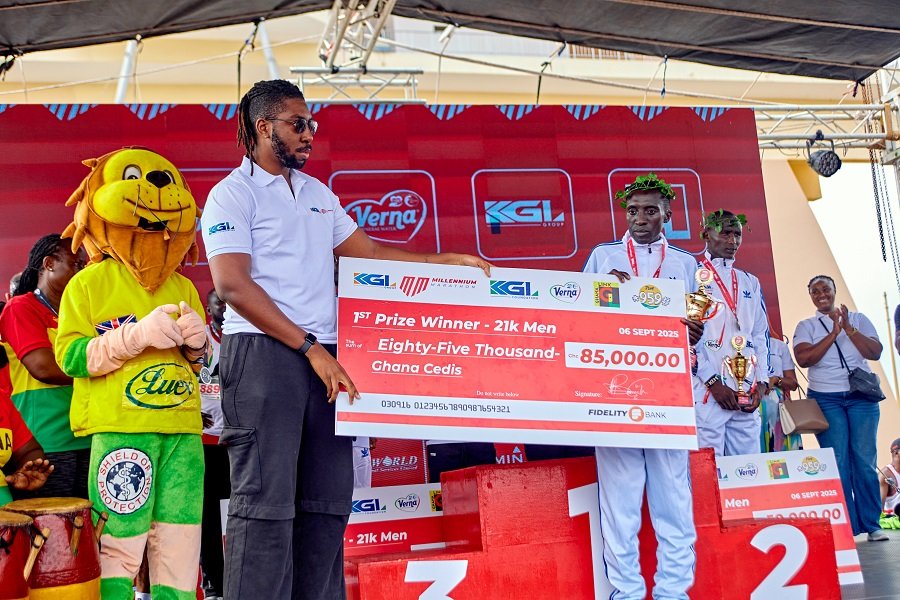 • Mr Dadey (left) presenting the winners prize to Gilbert Kiprotich