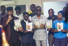 Mr Yaw Ampofo (left), together with Dr Blessing Ackah, Mr Darko-Mensah, and other dignitaries, after unveiling a sample of the booklet