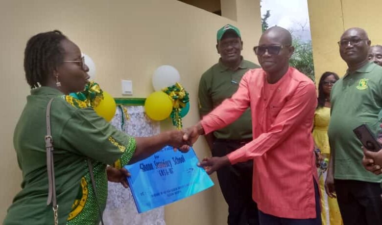 • Madam Adu handing over the project documents to Mr Dunoe (right)