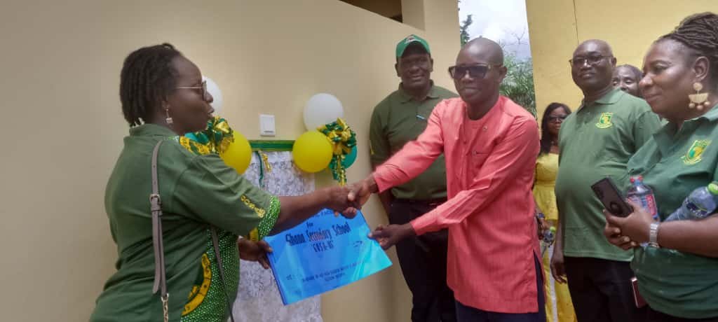 • Madam Adu handing over the project documents to Mr Dunoe (right)