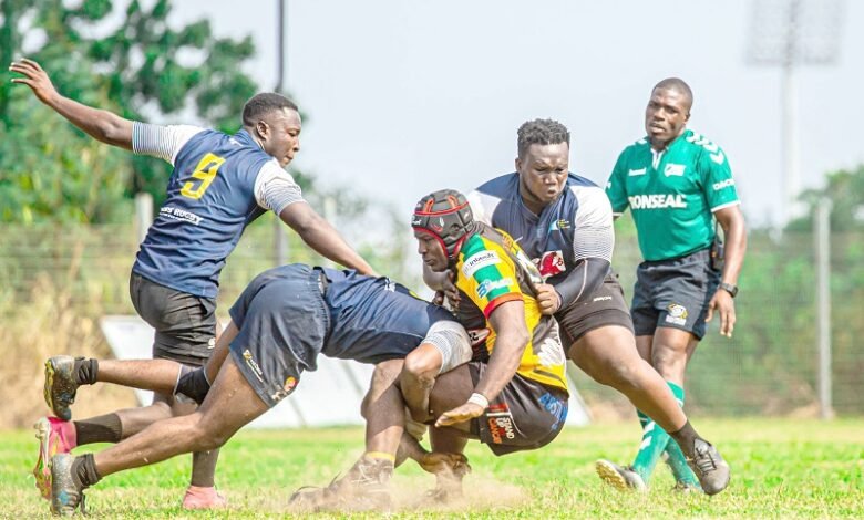 • Oliver Puman of Tigers (in yellow) being tackled by two Accra Panthers players
