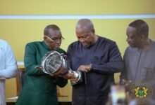 President Mahama (middle) and Mr Bagbin (left) inspecting the trophy