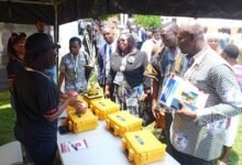 • Officials and participants inspecting an exhibition mounted as part of the conference