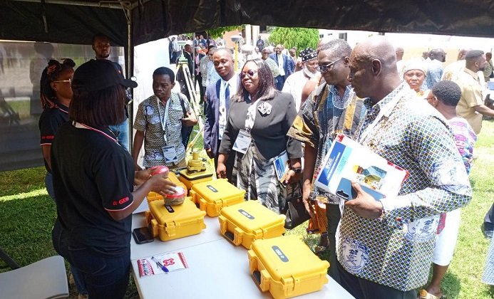 • Officials and participants inspecting an exhibition mounted as part of the conference