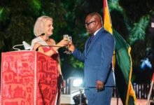 • Mrs Giger proposing a toast with Mr Issifu at the Switzerland National Day celebration in Accra