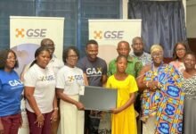 • Ms Amoah (fifth from left) with some senior officials of GSE presenting a laptop to the Dzorwulu Special School