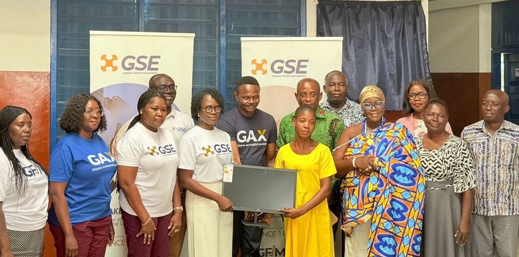 • Ms Amoah (fifth from left) with some senior officials of GSE presenting a laptop to the Dzorwulu Special School