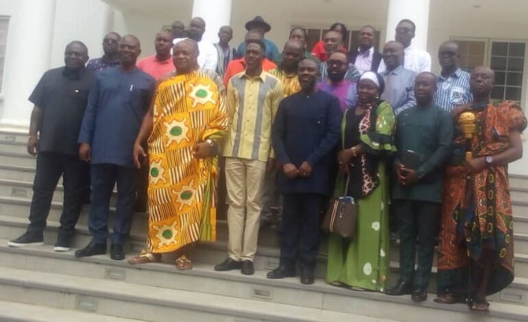 Togbe Afede XIV (third from left, front row) and Mr Courage Nunekpeku (second from left) with other officials