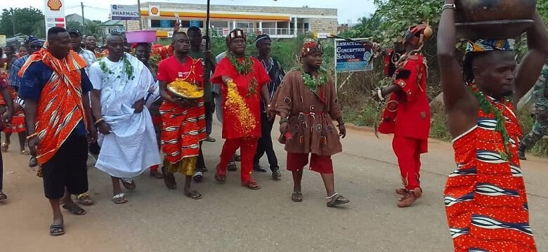 • Nii Dzahaa Sprinkling the Kpokpoi