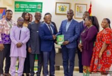 Mr Boadi-Mensah (fifth from left) presenting a copy of the book to Mr Iddrisu (fourth from left), while other senior staff of the two institutions look on