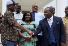 • Togbe Afede (left) in a handshake with the CEO of HTH