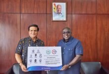 • Mr Julius Debrah (right) receiving the scholarship programme from an official of B5 and DPS International