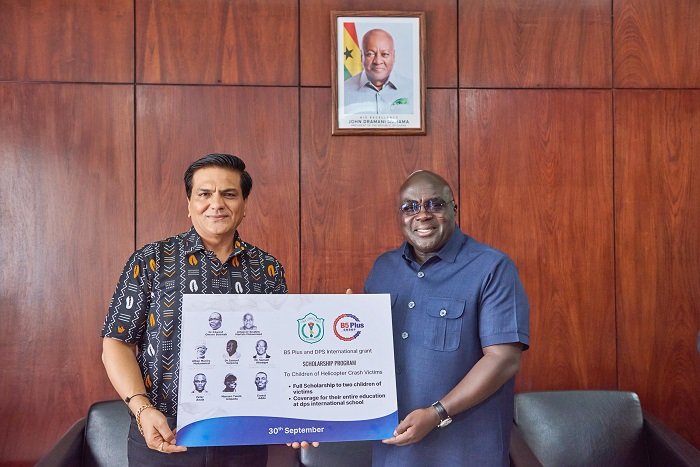 • Mr Julius Debrah (right) receiving the scholarship programme from an official of B5 and DPS International