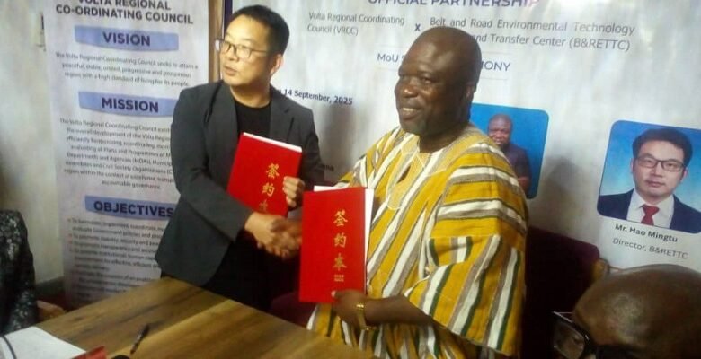 • Mr Gunu exchanging the MoU with his Chinese counterpart