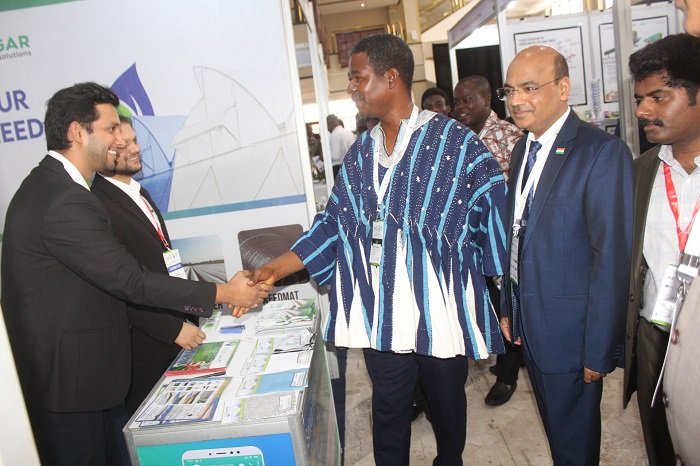 • Mr Harry Blemponny (in smock) and Mr Manish Gupta inspecting one of the exhibition stands Photo: Ebo Gorman