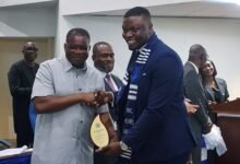 • Mr Agbodza (left) handing over the award to Mr Kweitsu