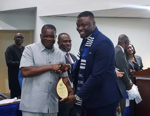 • Mr Agbodza (left) handing over the award to Mr Kweitsu