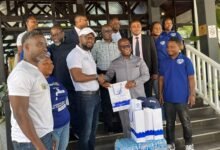 • Mr Otoo (second from left) presenting items to Mr Eduaful