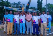 • Air Vice Marshal, Agyen-Frempong with the King's Baton flanked by Mr Akpokavie(left), officers of the Ghana Air Force and members of the Commonwealth Sports Ghana