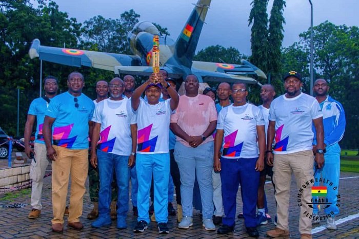 • Air Vice Marshal, Agyen-Frempong with the King's Baton flanked by Mr Akpokavie(left), officers of the Ghana Air Force and members of the Commonwealth Sports Ghana