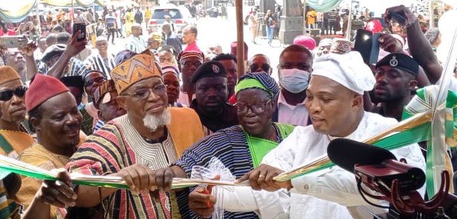 Mr Ablakwa (right) being assisted by other dignitaries to cut the tape to open the new passport office