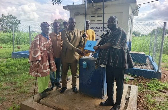 • Mr Kponyo (right) handing over a mechanised borehole facility to Mr Joseph Akasake Abaah (left) at Dua-Yikene in Bongo