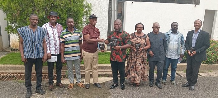 • Mr Gunu (fifth from right) receiving a packaged coffee from Mr Benjamine Atidjah
