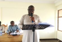 Mr Isaiah Kudjoe Dordoe (inset) addressing the Assembly meeting at Kpassa in the Oti Region