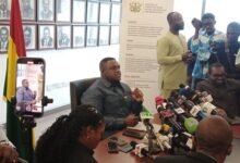 Mr George speaking at the press conference