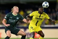 Erling Haaland in a tussle for the ball with Villarreal's Thomas Partey
