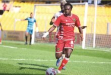 • Lord Hilary Adobo controls the ball ahead of his marker Stephane Aziz Ki