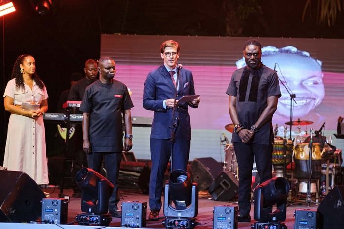 • Mr Landshoeft (middle) presenting a citation to Roman Father (right), Manager of Daddy Lumba at the event