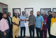 • Mr Awal (fourth from left) with Mr Obeng (fifth from right) after signing the MoU