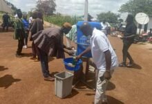 • Community members demonstrating appropriate handwashing techniques during the commemoration of the Global Handwashing Day