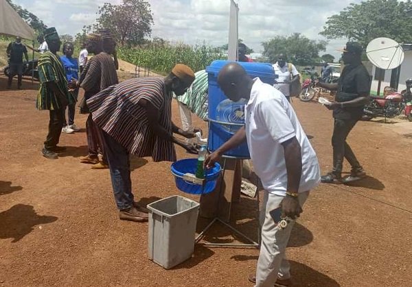 • Community members demonstrating appropriate handwashing techniques during the commemoration of the Global Handwashing Day