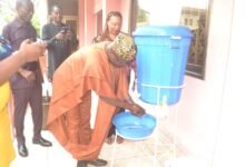 • Mr Ahmed Ibrahim washing his hands Photo: Victor A. Buxton