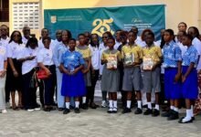 • Members of the group with some students displaying some of the donated books