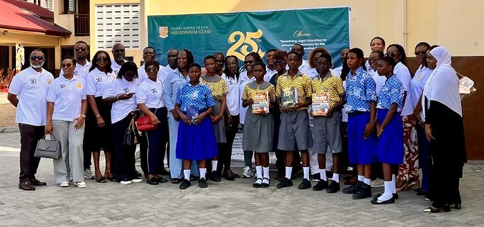 • Members of the group with some students displaying some of the donated books